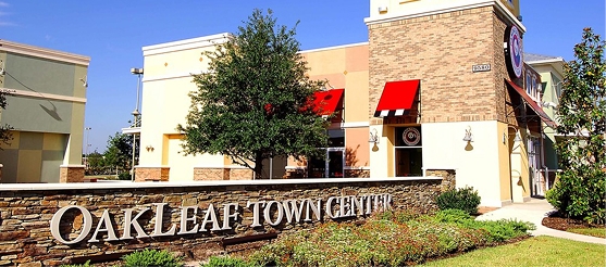 Oakleaf Town Center entrance with retail shops and red awnings in Oakleaf Plantation near Orange Park, FL.