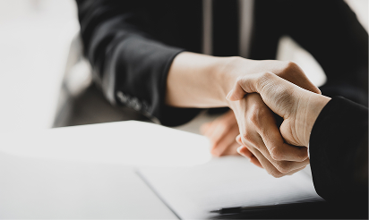 Close-up of professional handshake between attorney and client, symbolizing trust in personal injury case.
